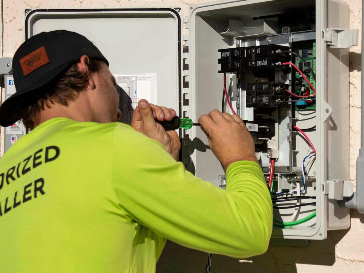 Électricien intervenant sur un tableau électrique ouvert lors d'un chantier